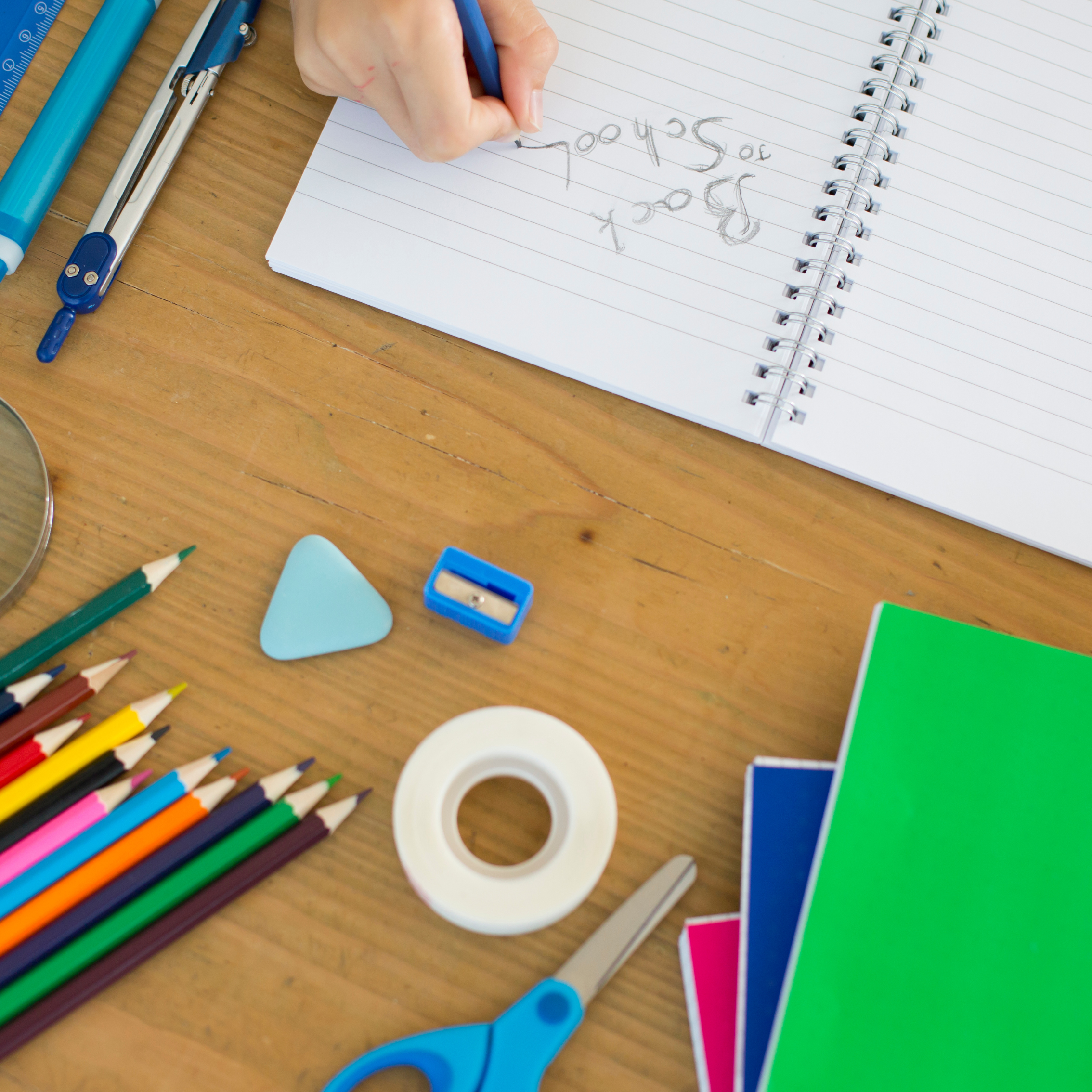 School supplies on a table with back to school written on a notepad