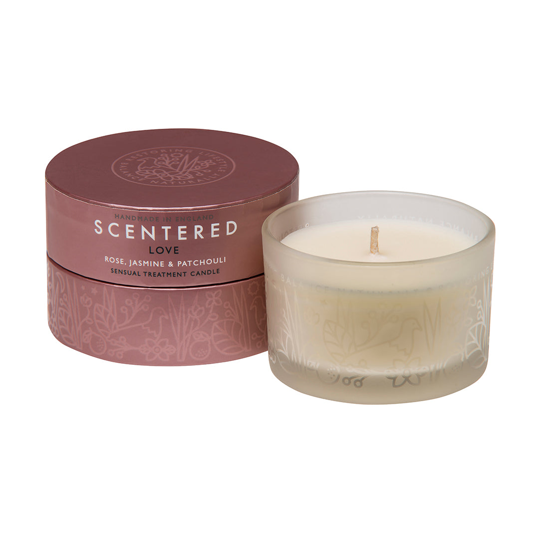 The Scentered Love travel candle next to its packaging, essential oil Rose, Patchouli, Cedarwood Candle for Hormone balance. 