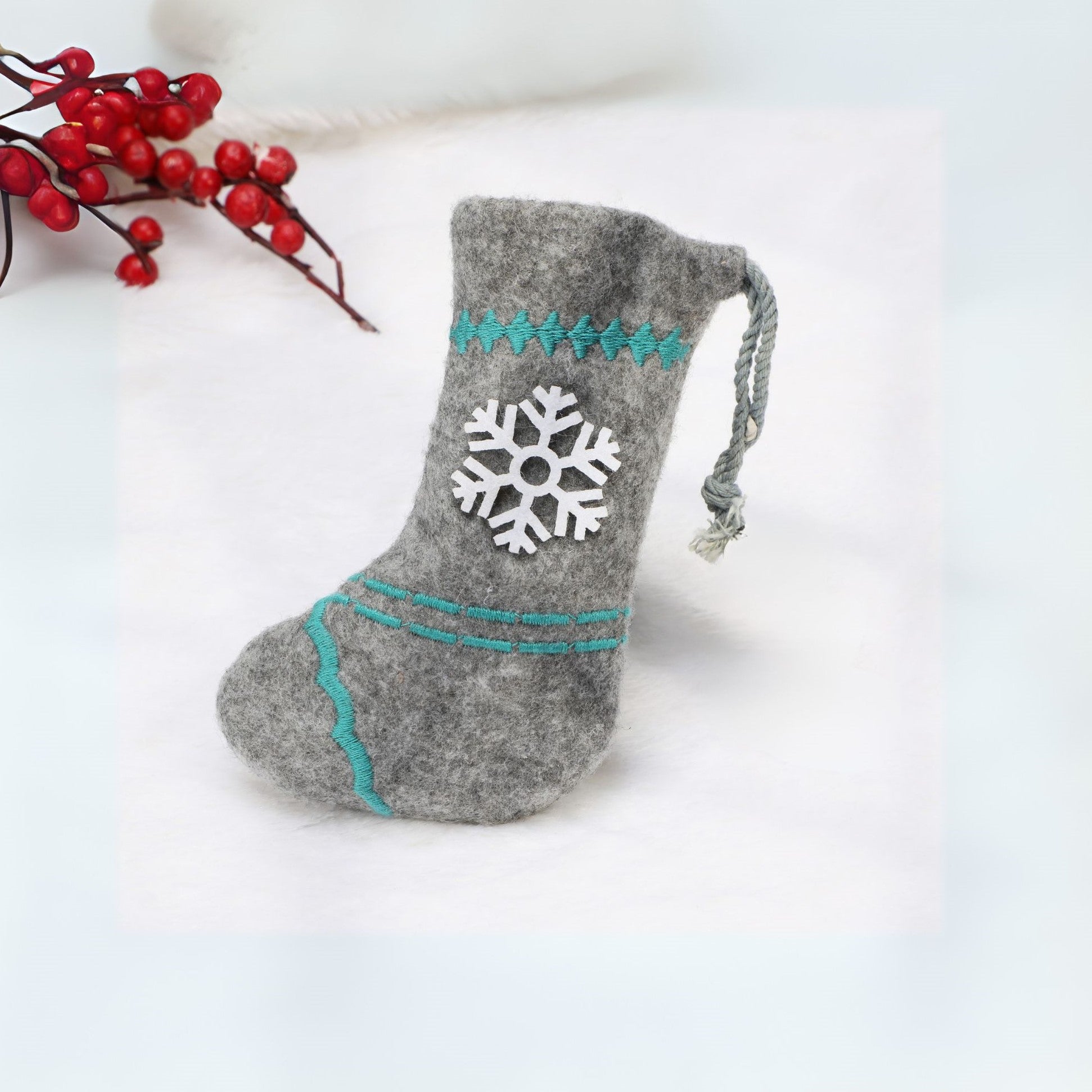 Reusable felt Christmas stocking with a festive snowflake pattern, ideal for sustainable holiday gifting.